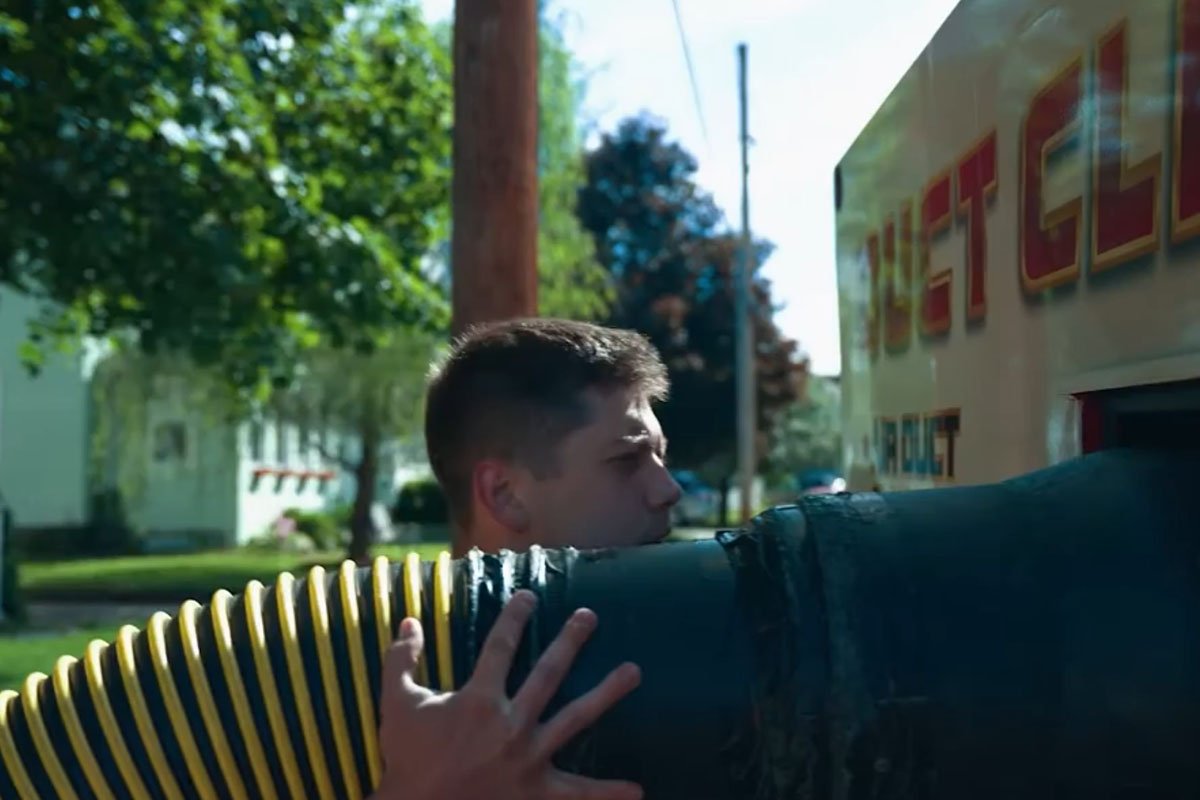 An HVAC technician using commercial duct cleaning equipment inside a greater Binghamton NY home to improve indoor air quality