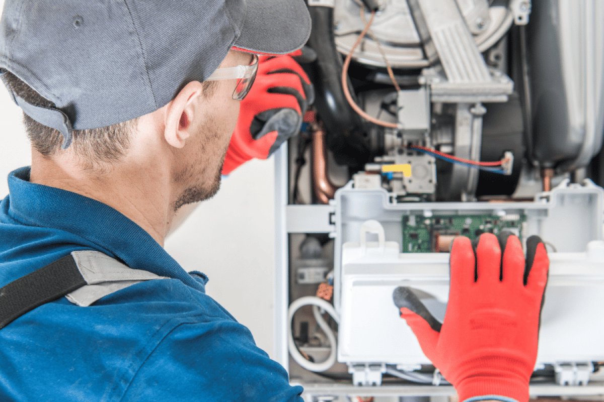 HVAC tech inspecting a heating system for safety hazards