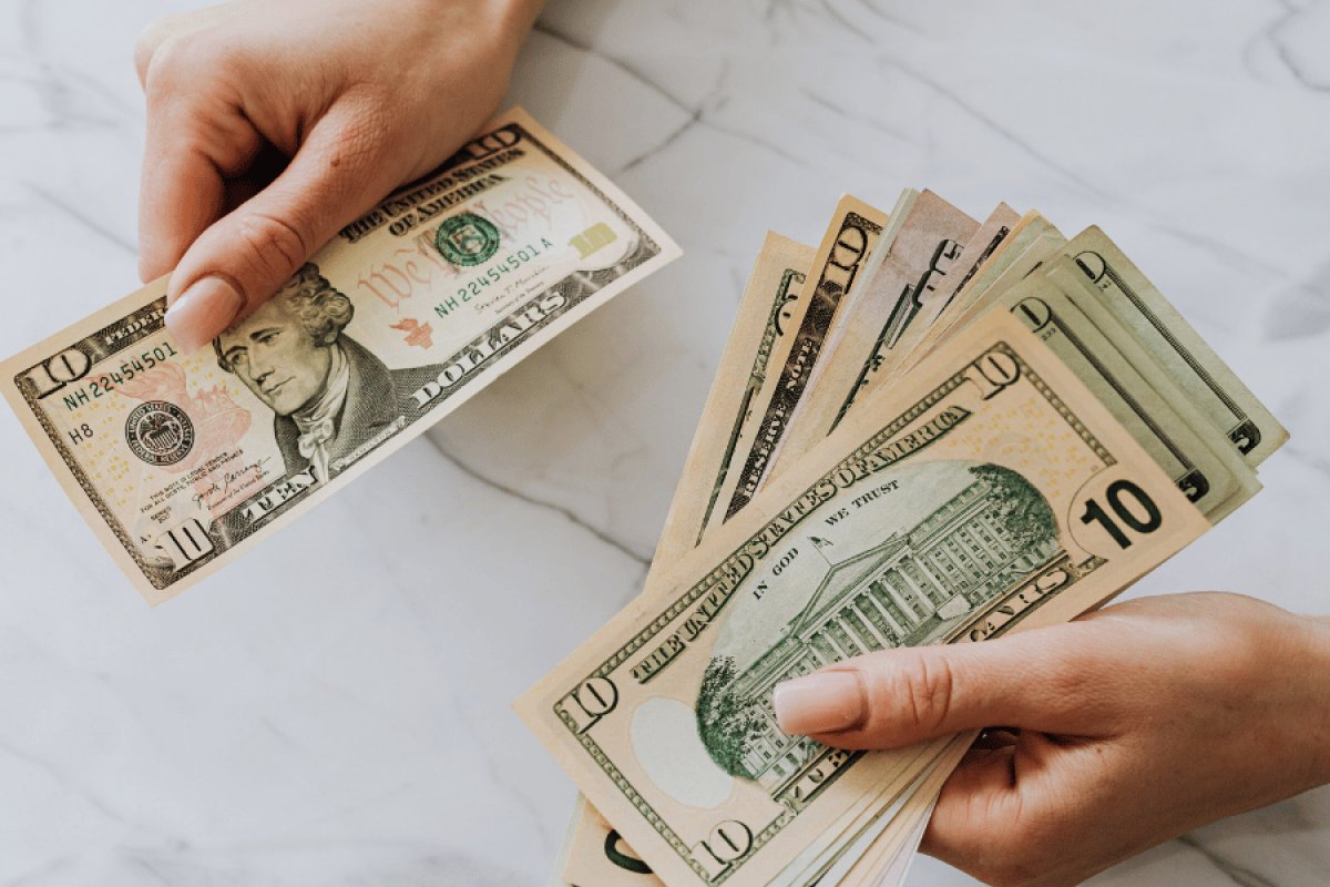 Woman counting money to see if she has enough for an AC replacement