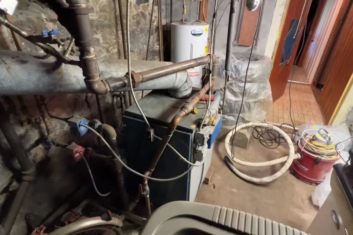 High-efficiency residential boiler installed in the basement of a Greater Binghamton home during a spring replacement project with copper piping and venting visible