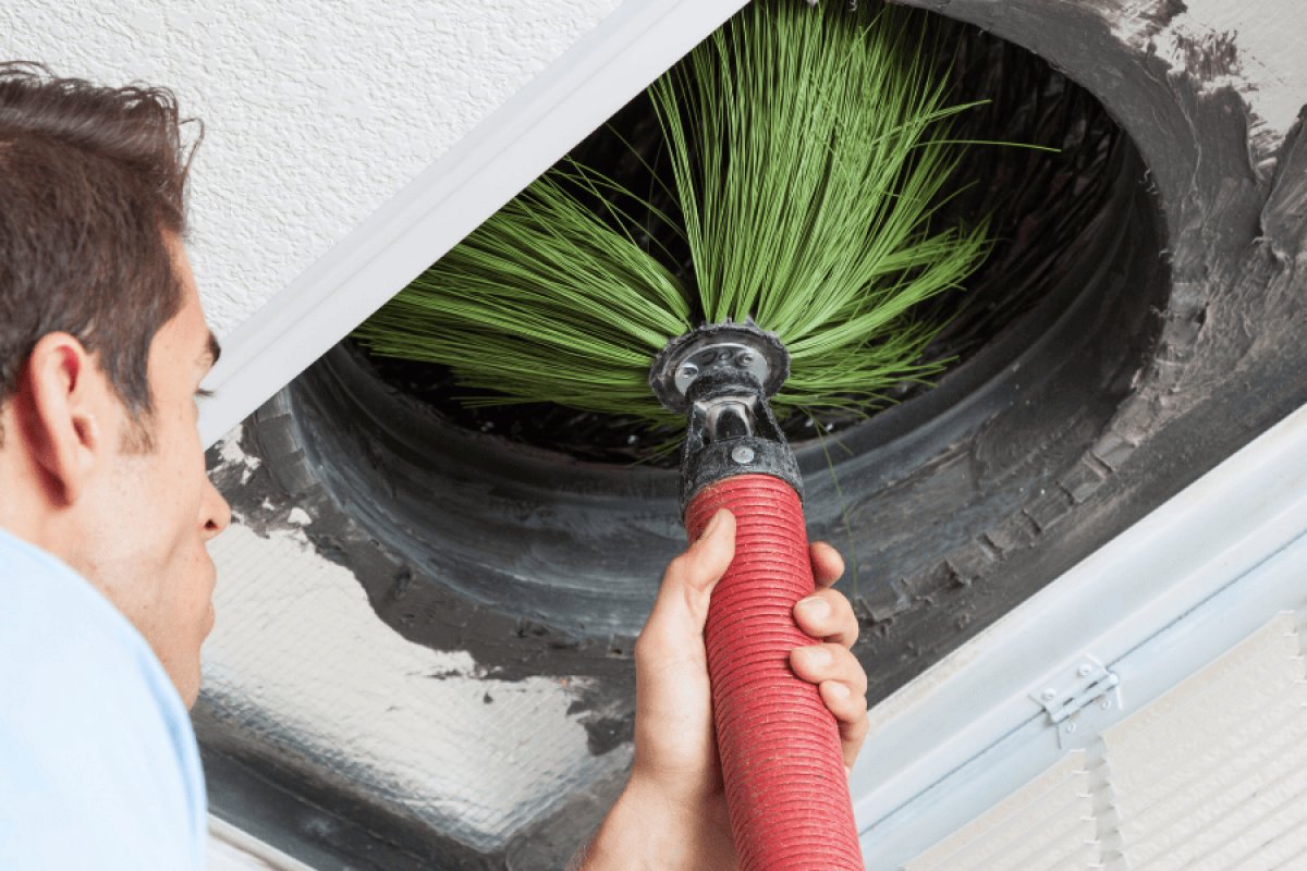 Technician cleaning air ducts