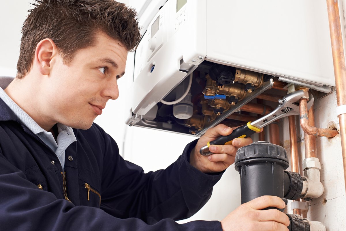 ANC Heating technician performing a summer boiler tune-up inspection on a residential boiler system in a Binghamton NY home