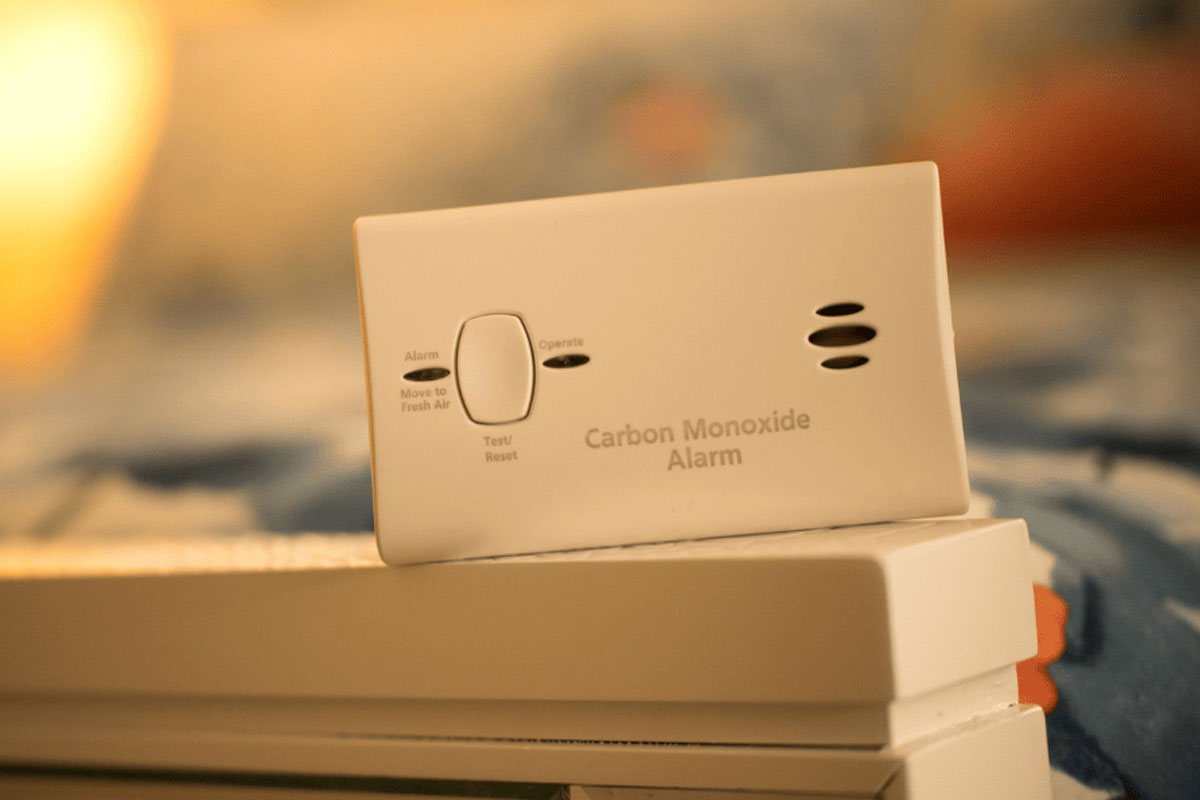 Carbon monoxide alarm sitting next to a flame
